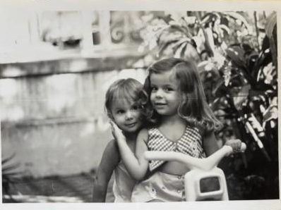 Duas meninas pequenas brincando, em foto antiga preto e branco
